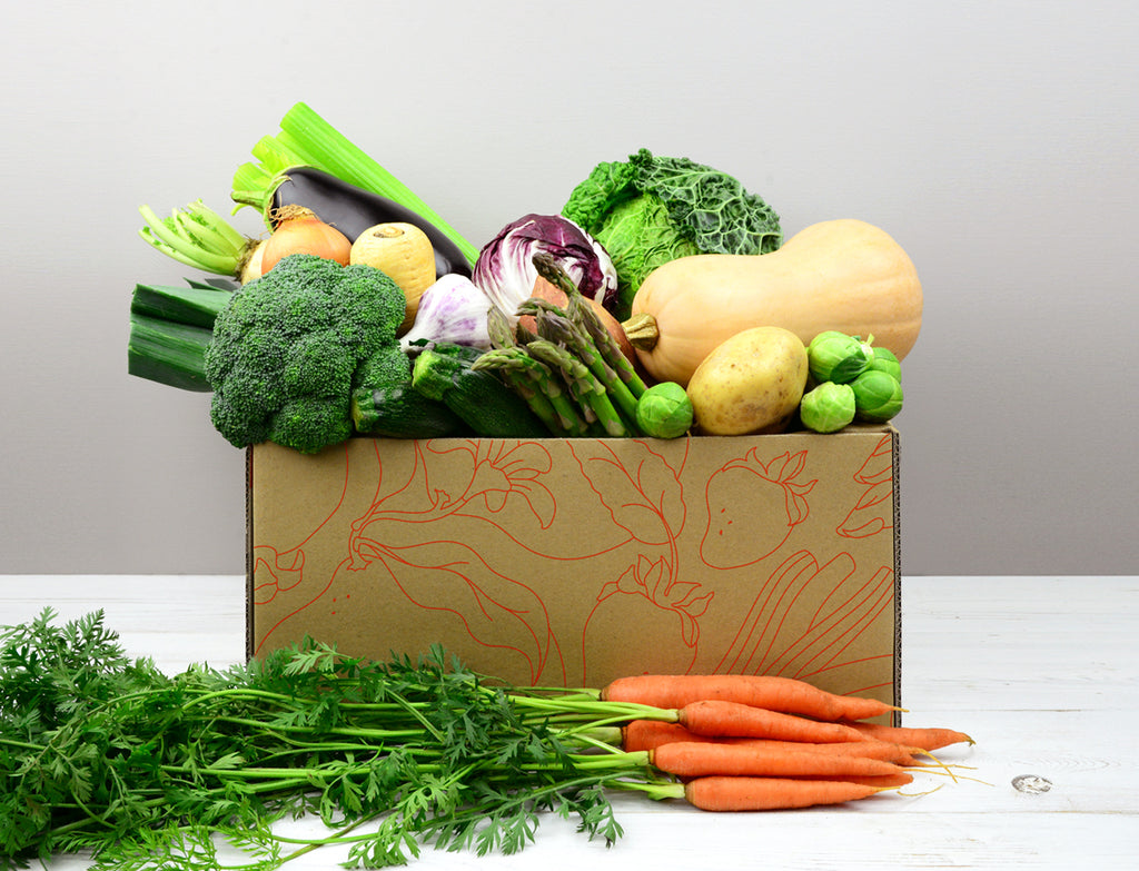 Vegetable Box containing salad, potatoes, carrots, onion, garlic and other seasonal vegetables