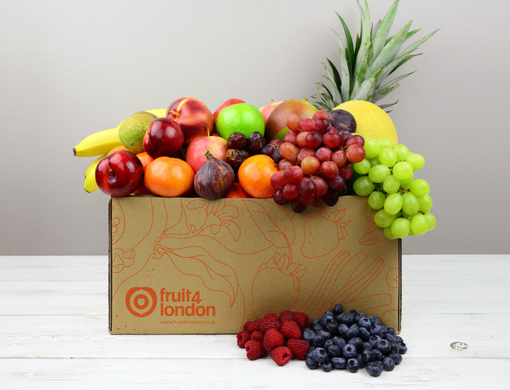 Apples, bananas, pears, clementines or satsumas and seasonal fruit with some grapes or berries in a Fruit Box