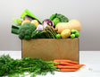Vegetable Box containing salad, potatoes, carrots, onion, garlic and other seasonal vegetables