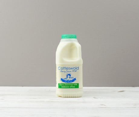 Cotteswold 1 pint of Semi Skimmed milk carton with a green cap ready for Home Delivery